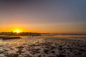 A picture of a beautiful sunrise or sunset of a peaceful beach scene